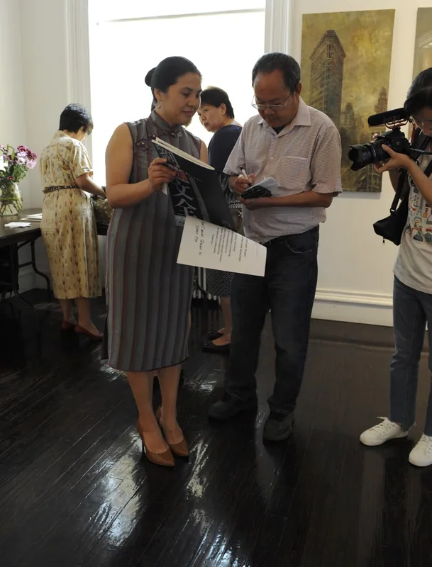 画作前的采访交流,旁有摄像人员记录